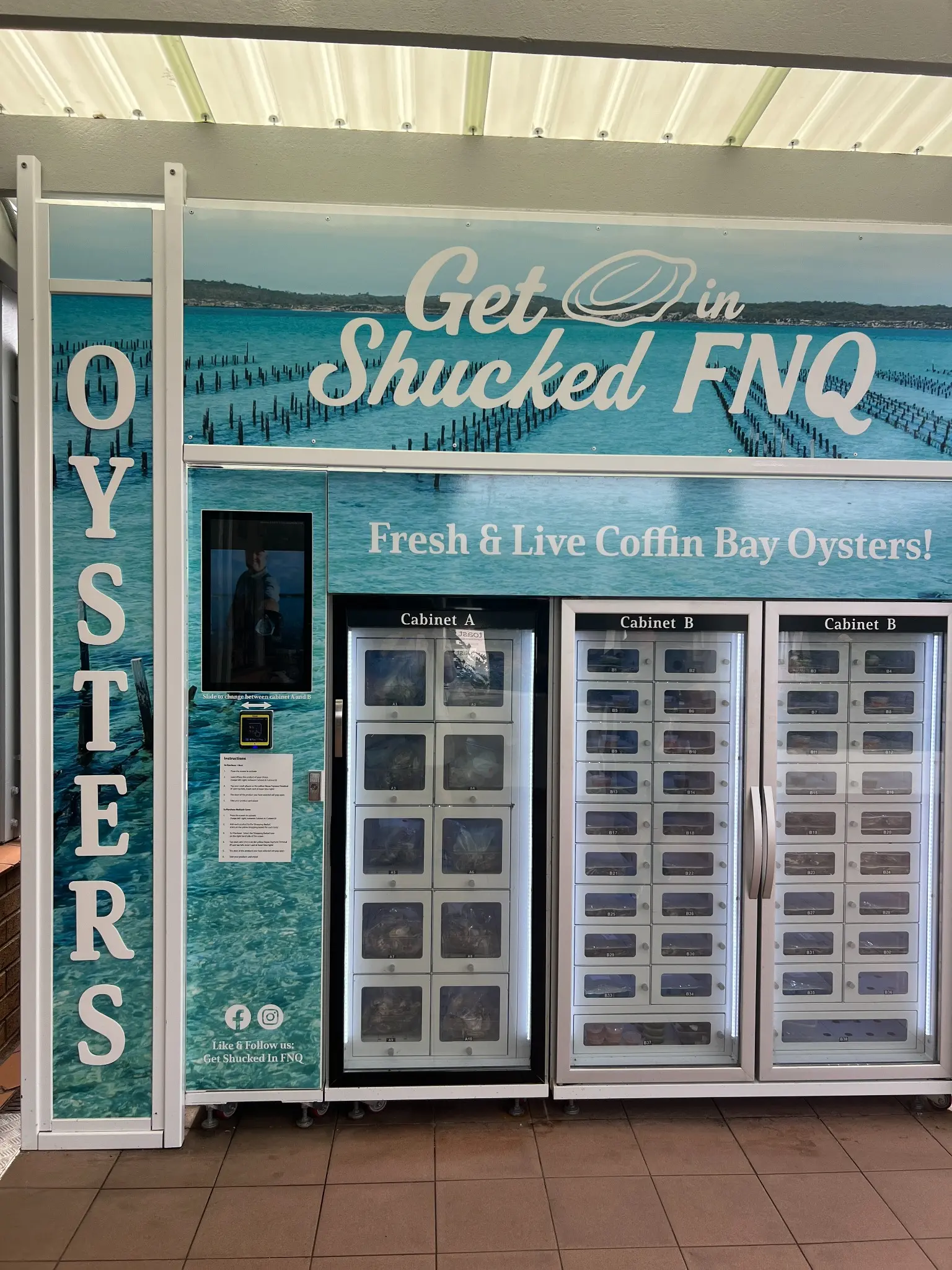 WEIMI custom oyster vending machine for Get Shucked FNQ in Port Douglas with ocean themed branding and glass front locker compartments
